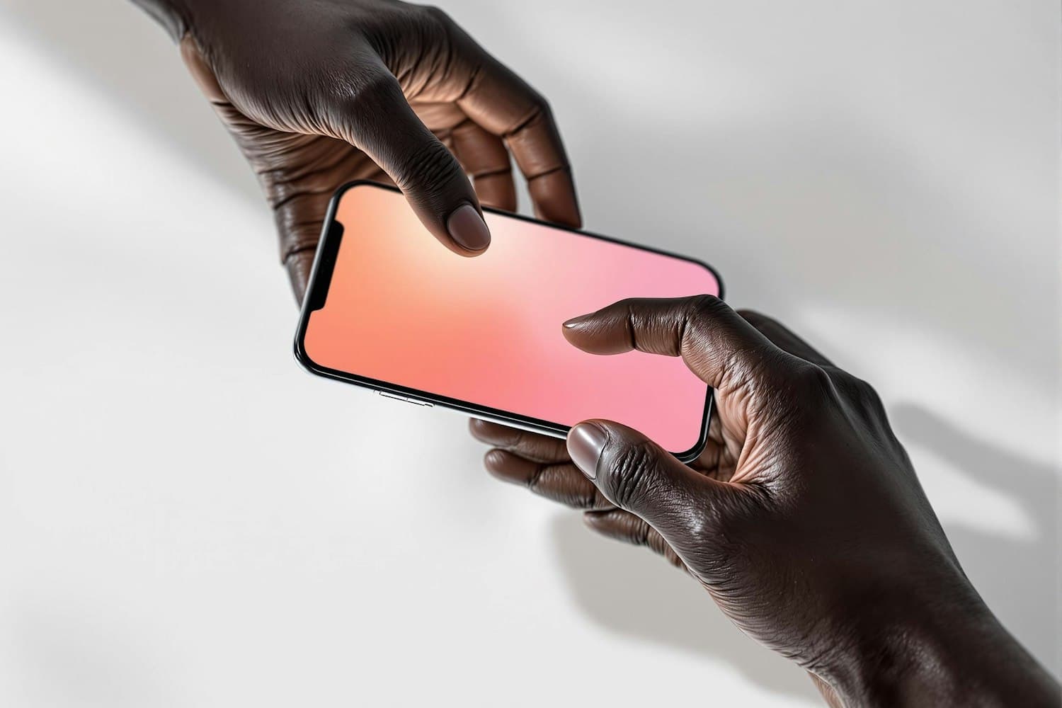 Two hands passing a phone with an app glowing in warm pink